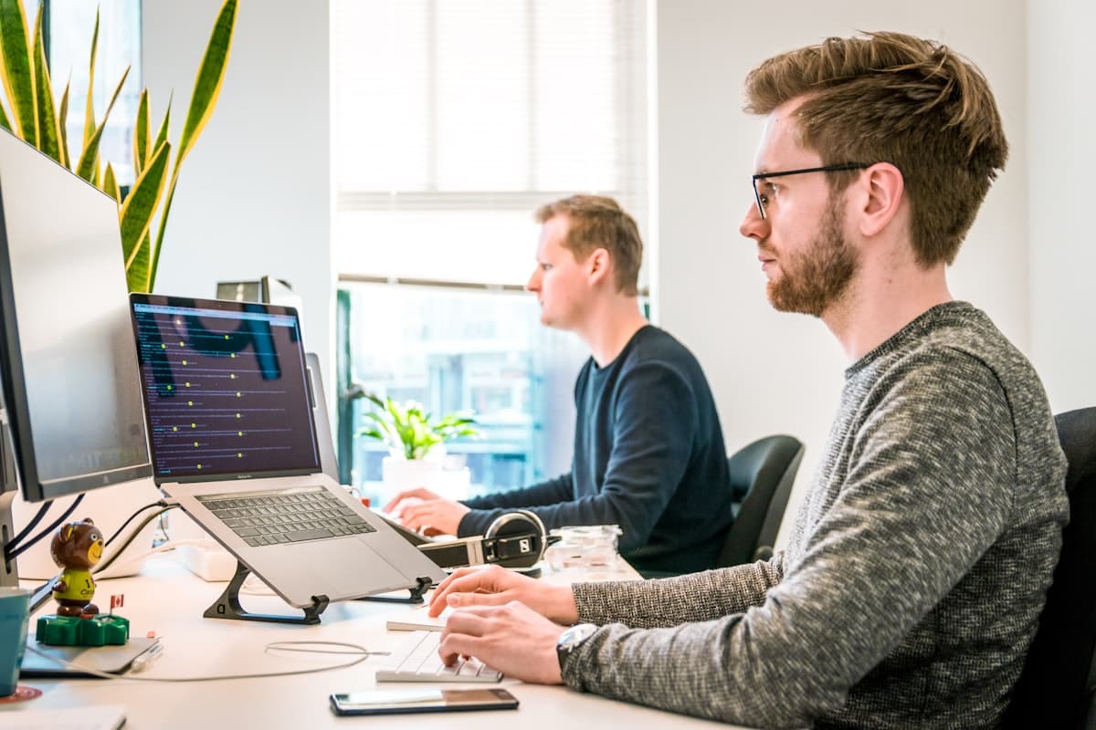 Team collaborating in an open office with laptops